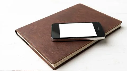 Cellphone and notebook Stock Photos