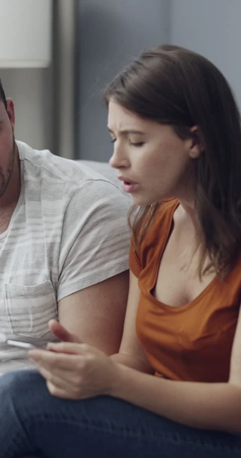 Cellphone, angry and couple with argument on sofa in living room for divorce, 動画素材 329778539