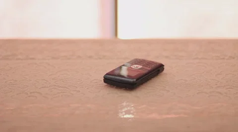 Cellphone antics - walk by and pick it up when it rings Stock Footage