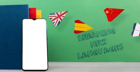 Cellphone apps for learning foreign languages. A smartphone, book and paper a Stock Photos