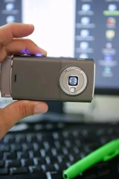 Cellphone camera, computer keyboard and screen Stock Photos