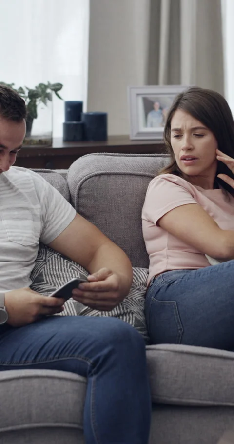 Cellphone, cheating and couple with argument on sofa in living room for divorce, 動画素材 329667050