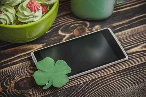 Cellphone with clover Stock Photos