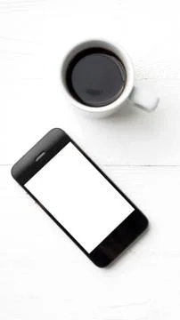 Cellphone with coffee cup Stock Photos