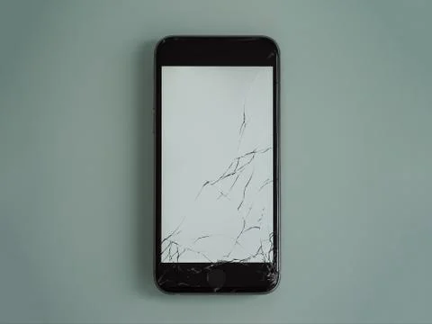 Cellphone with cracked screen on. Stock Photos