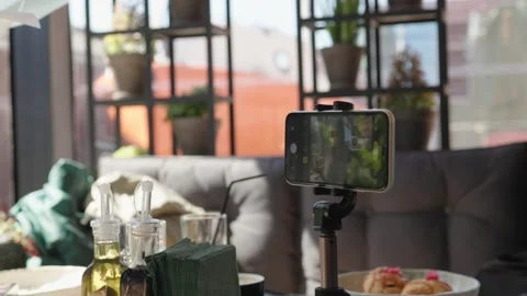 Cellphone device vlog shooting video cafe smartphone stand tripod table camera Stock Footage 241186344