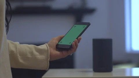 Cellphone with green screen turning on an Amazon Echo Stock Footage 102192223
