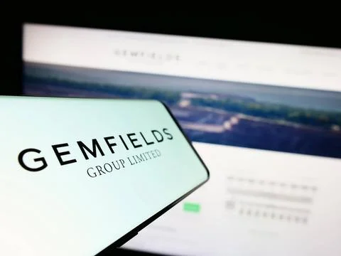  Cellphone with logo of mining company Gemfields Group Ltd. on screen in f... Stock Photos
