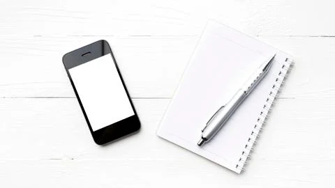 Cellphone with notepad and pen Stock Photos