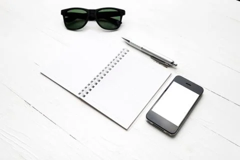 Cellphone with notepad and pen Stock Photos