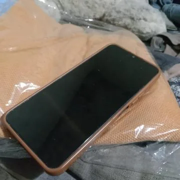 A cellphone on a pile of clothes Stock Photos