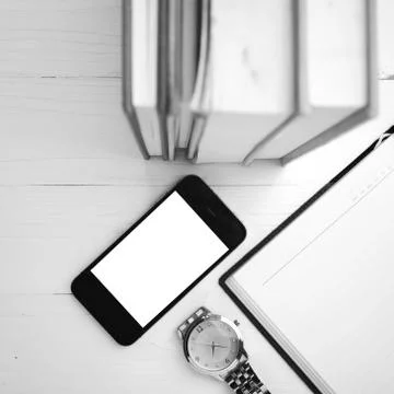 Cellphone with stack of book and watch black and white tone color style Stock Photos
