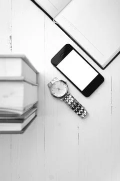 Cellphone with stack of book and watch black and white tone color style Stock Photos