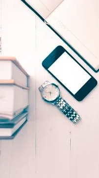 Cellphone with stack of book and watch vintage style Stock Photos