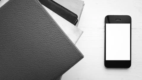 Cellphone with stack of book black and white tone color style Stock Photos