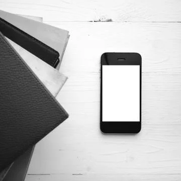 Cellphone with stack of book black and white tone color style Stock Photos
