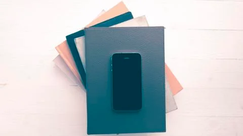 Cellphone with stack of book vintage style Stock Photos