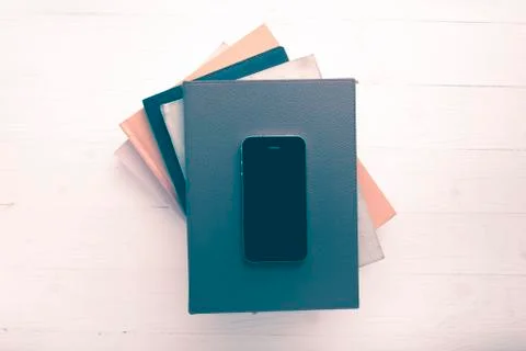 Cellphone with stack of book vintage style Stock Photos