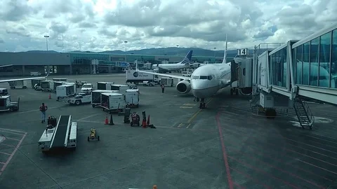 A cellphone time-lapse of a airplane docking in Tocumen international Airport in Stock Footage 98248848