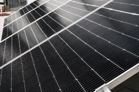 Cells of black solar panel in closeup. Renewable green Energy system Stock Photos
