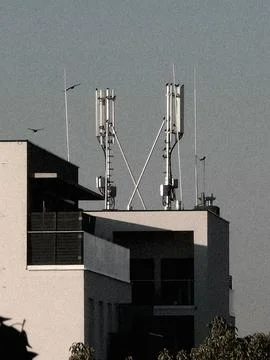 Cellular antennas on modern rooftop Stock Photos