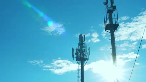 Cellular Communication Stations, Cell Towers in the Rays of the Sun on a Sunny D Stock Footage 224460003