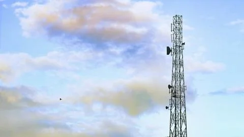 Cellular communication tower against the background of the sky Stock Photos