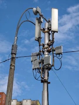 A cellular communication tower mounted on a low pole, standing next to a ro.. Stock Photos