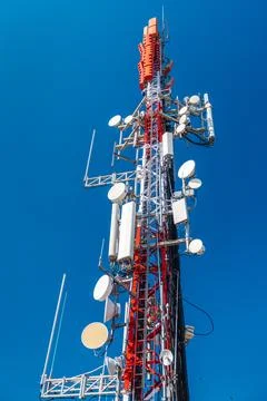 Cellular communication tower with multiple antennas and transmitters agains.. Stock Photos