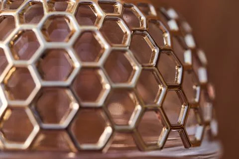 Cellular grate on glassware. Macro effect photo.Close-up. Stock Photos