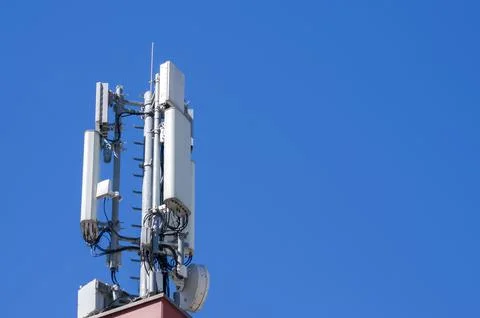 Cellular network 5g-4g antenna tower under blue sky in Lugano Stock Photos