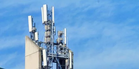 Cellular network antenna array mounted on concrete rooftop tower Stock Photos