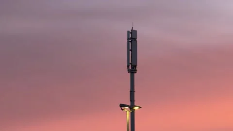 Cellular network tower under pink sky panning Stock Footage 330948113