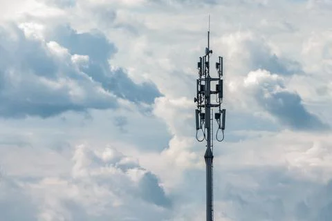 Cellular network transmission tower on cloudy sky background, copy space Stock Photos