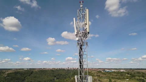 Cellular Telecommunication Tower with Wind Turbines Background Stockbeeldmateriaal 347060152