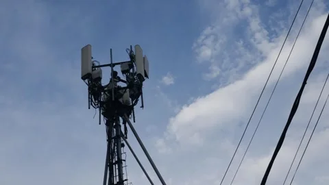 Cellular telecommunications tower with antennas Stock Footage 319523028