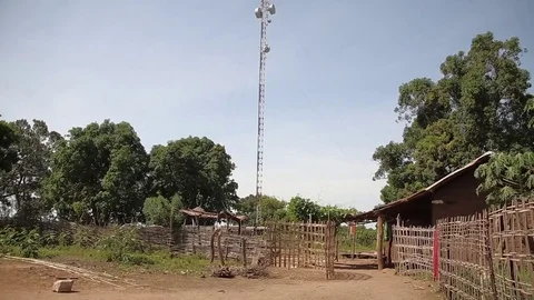 Cellular telephone mast antenna in a village - guinea africa Stock Footage
