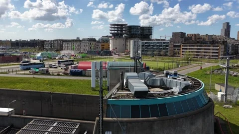 Cellular tower and ventilation system on an industrial building rooftop Stock Footage 335624609