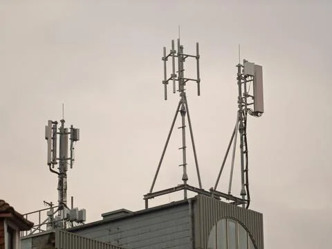 Cellular Tower Array on Urban Building Roof Fotos de archivo