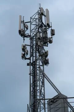Cellular tower with mobile telecommunication transmitters on sky backdrop Stock Photos