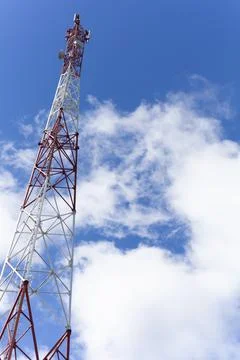 Cellular tower in summer against the blue sky 库存照片