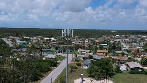 Cellular Tower Surrounded by Pioneers Loop Homes, Freeport Bahamas Drone View Stock Footage 90105550