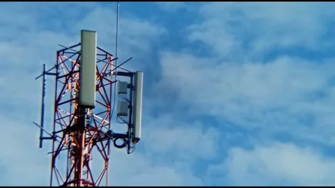 A cellular transmitter tower and blue sky Stock Footage 310194167