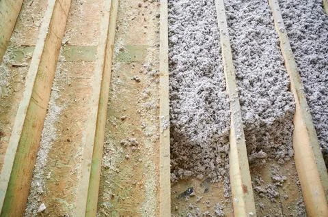 Cellulose paper insulation installed between floor joists in frame home Stock Photos