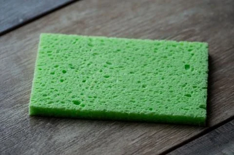 Cellulose sponge kitchen objects on the wood texture background. Cellulose na Stock Photos