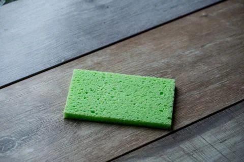 Cellulose sponge kitchen objects on the wood texture background. Cellulose na Stock Photos