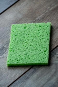 Cellulose sponge kitchen objects on the wood texture background. Cellulose na Stock Photos
