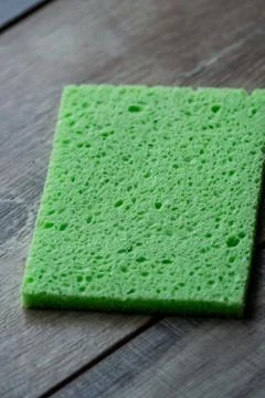 Cellulose sponge kitchen objects on the wood texture background. Cellulose na Stock Photos