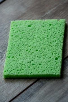 Cellulose sponge kitchen objects on the wood texture background. Cellulose na Stock Photos