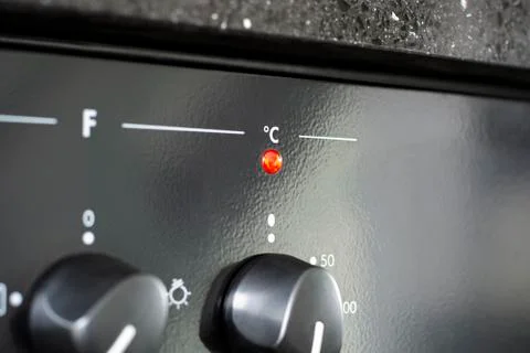 Celsius with red indicator light. Heating up the oven in kitchen Stock Photos